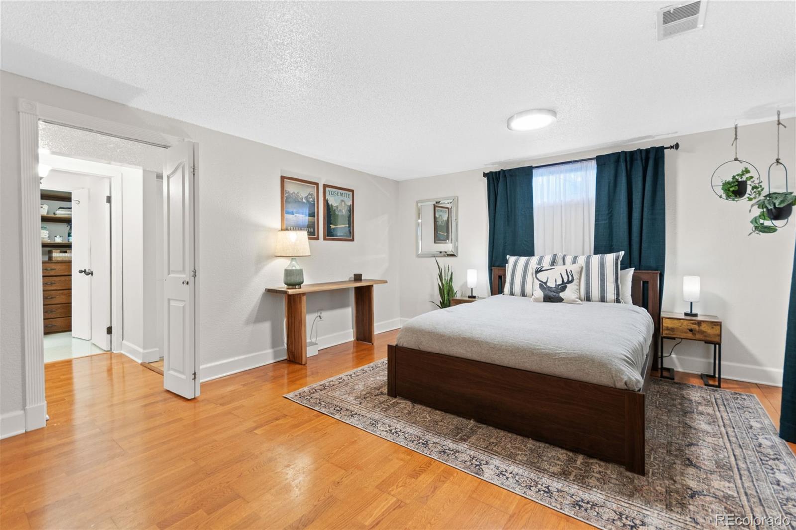5366 Field Circle Arvada, CO 80002 - Photo 31 of 50 a spacious bedroom with a bed and table chair