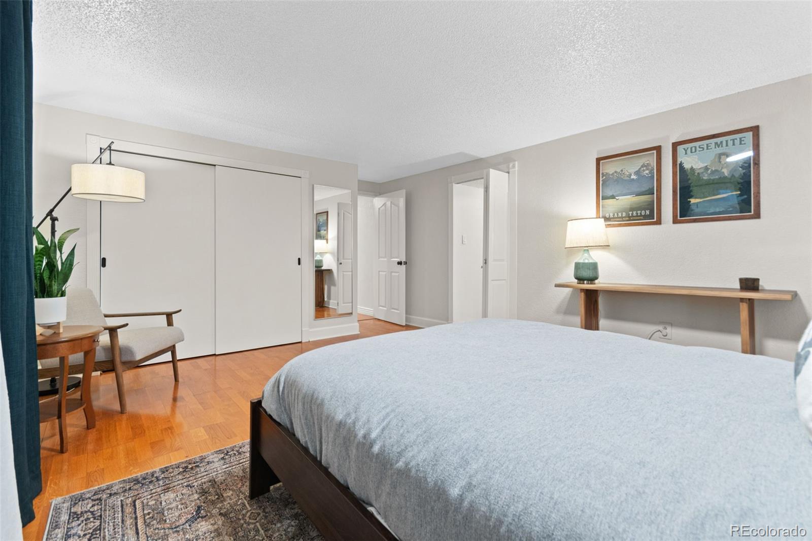 5366 Field Circle Arvada, CO 80002 - Photo 32 of 50 a spacious bedroom with a bed and a table in it