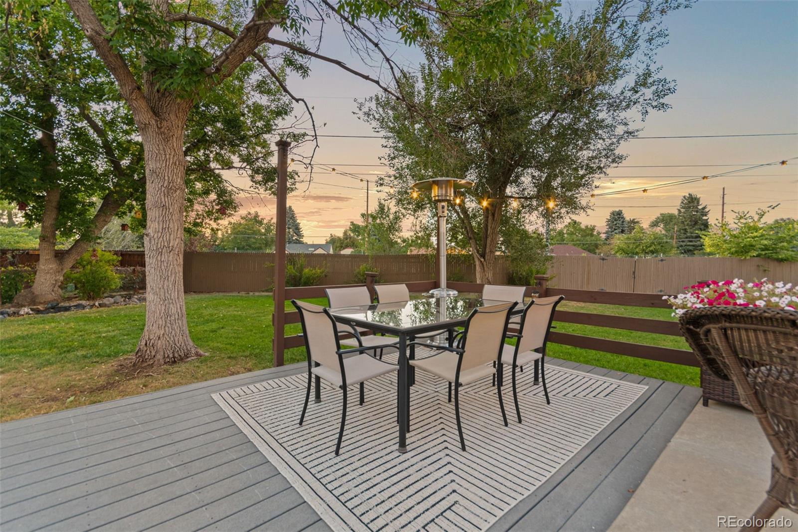 5366 Field Circle Arvada, CO 80002 - Photo 42 of 50 a view of a chairs and table on the wooden deck
