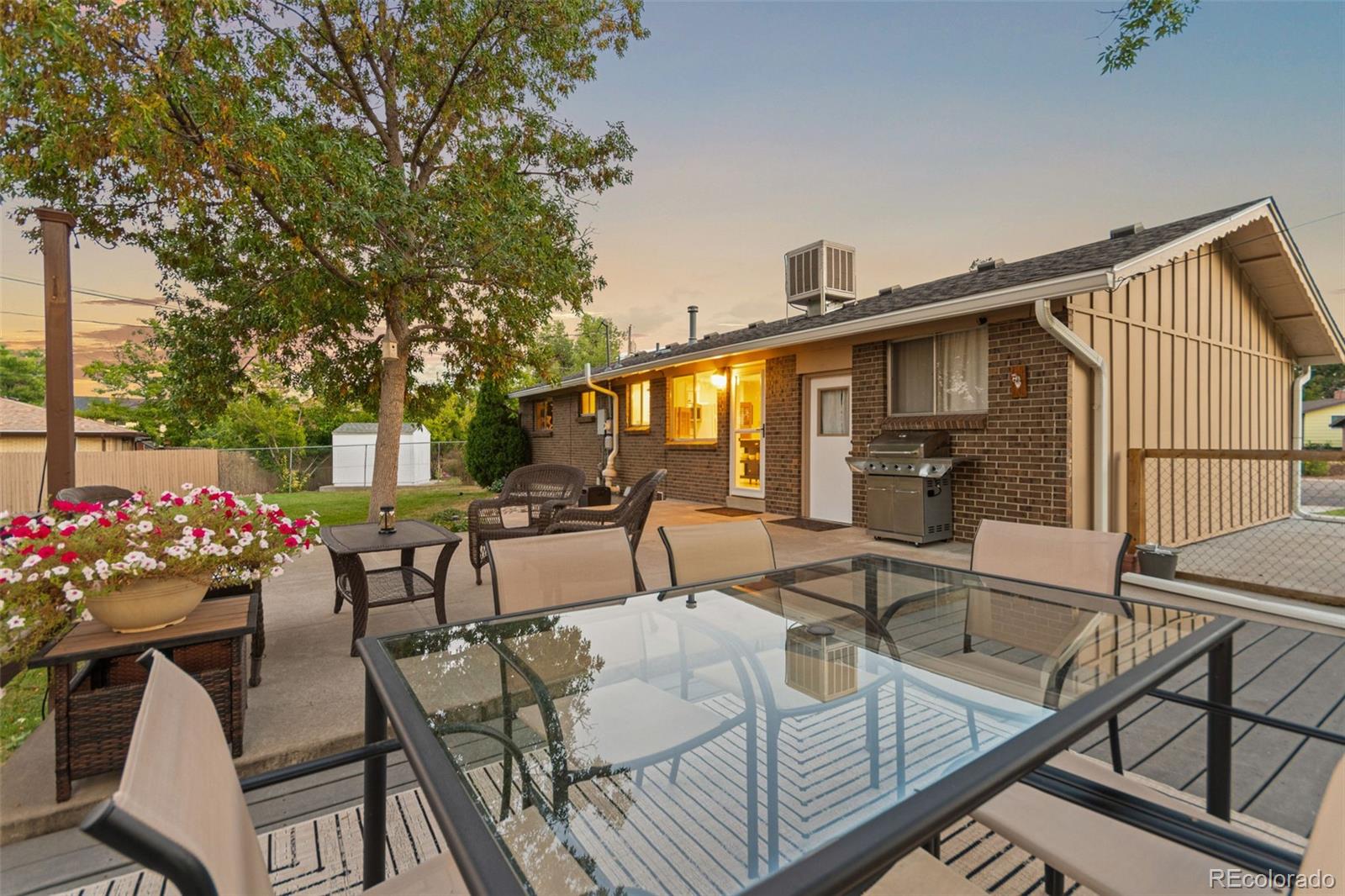 5366 Field Circle Arvada, CO 80002 - Photo 43 of 50 a view of a patio with couches table and chairs and potted plants