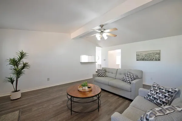 a living room with furniture and a lamp