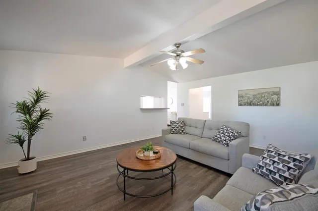 a living room with furniture and a lamp