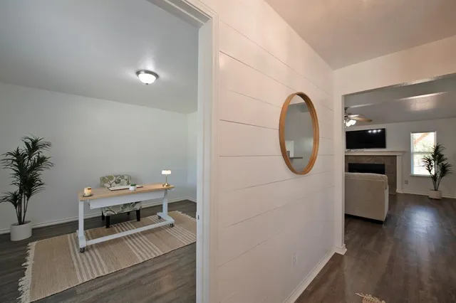 a living room with furniture a table and wooden floor