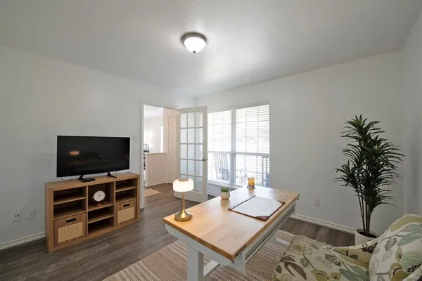 a living room with furniture and a flat screen tv