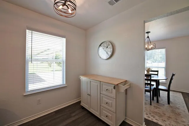 a view of a room that has a window and a chair