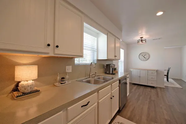 a kitchen with wooden floors and fireplace