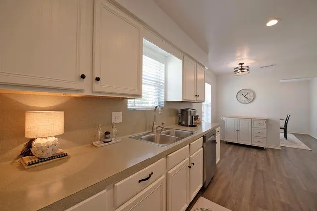 a kitchen with wooden floors and fireplace