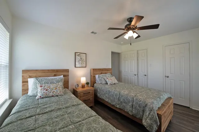 a bedroom with two beds and a chandelier