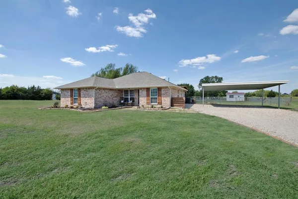 a view of a house with a yard porch and sitting area