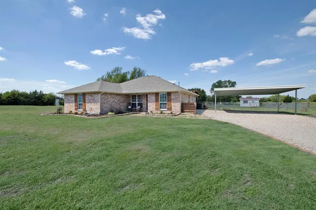 a view of a house with a yard porch and sitting area