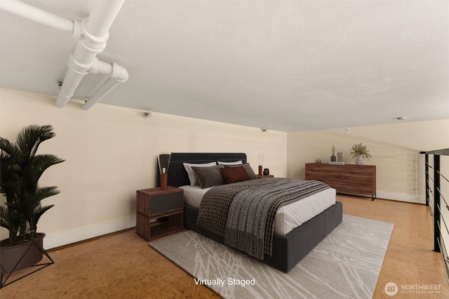 a spacious bedroom with a bed and a potted plant