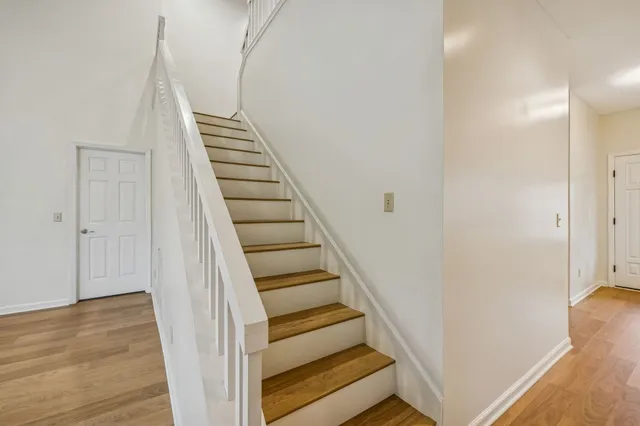 a view of a staircase with wooden floor and entryway
