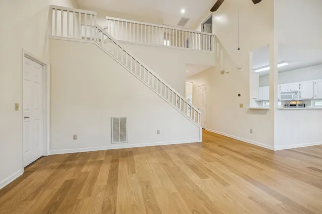 a view of empty room with wooden floor