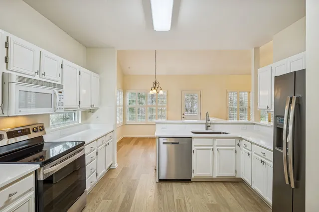 a kitchen with a sink stove and refrigerator