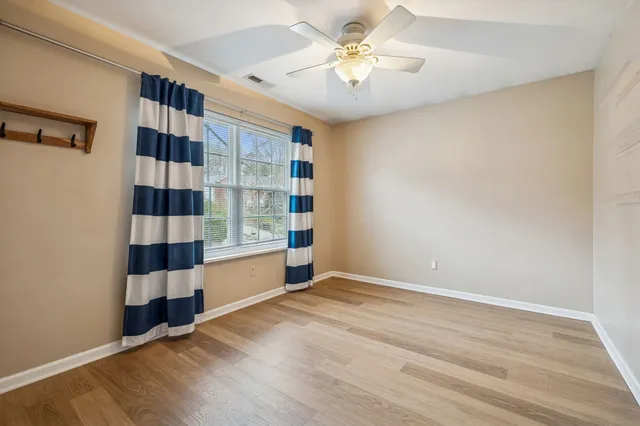 wooden floor in an empty room with a window