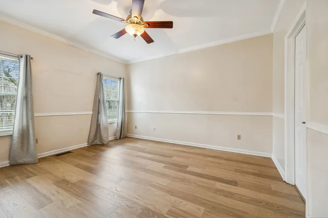a view of an empty room with wooden floor