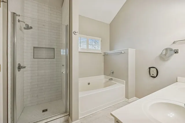 a bathroom with a bathtub and shower