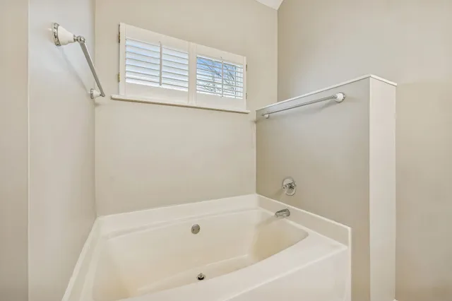 a bathroom with a tub and a shower