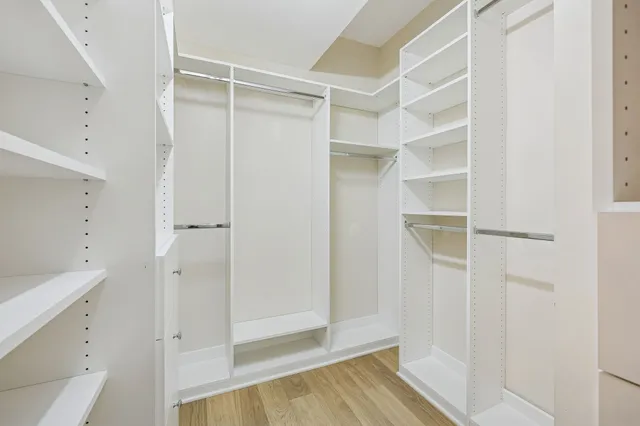 a view of walk in closet with empty racks