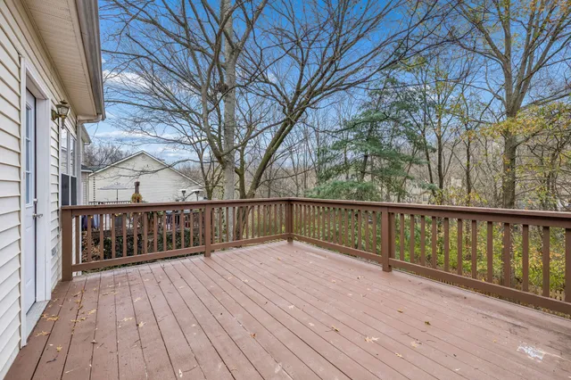a view of balcony with wooden floor and fence