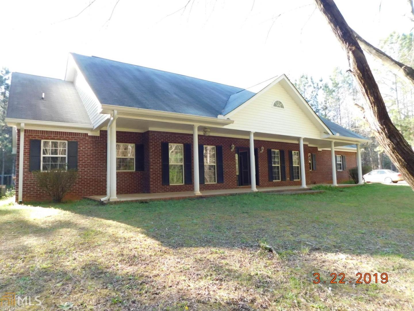 715 Hood Road, Unit 12 Concord, GA 30206 - Photo 1 of 1 a view of a yard in front of a house with large trees