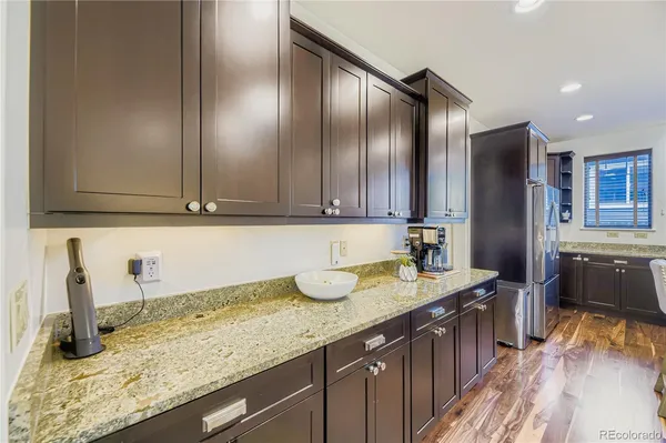 a kitchen with granite countertop stainless steel appliances and wooden cabinets