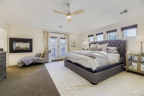 a bedroom with a bed couch and a window