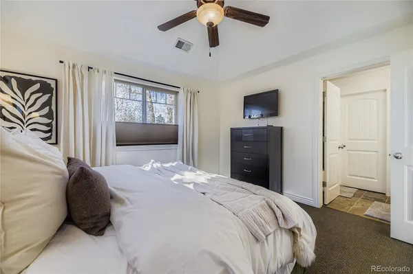 a bedroom with a bed and a television