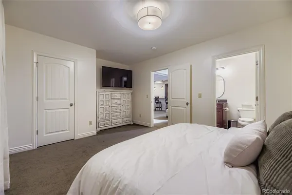 a bedroom with a bed and a television