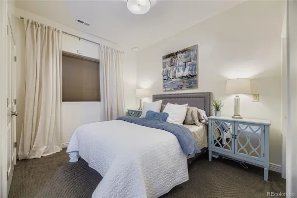 a bedroom with a bed and a night stand