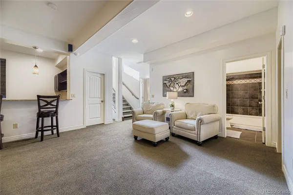 a living room with furniture and a balcony