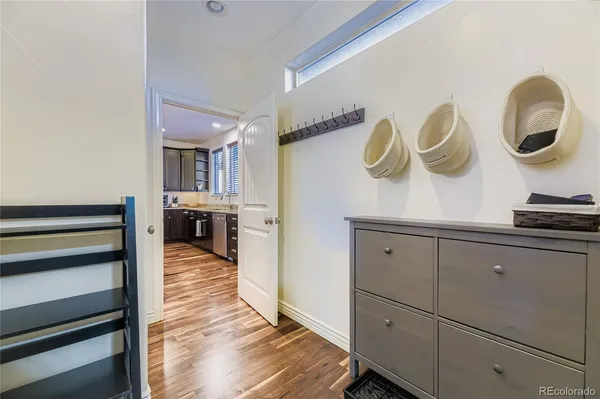 a kitchen with cabinets and wooden floor