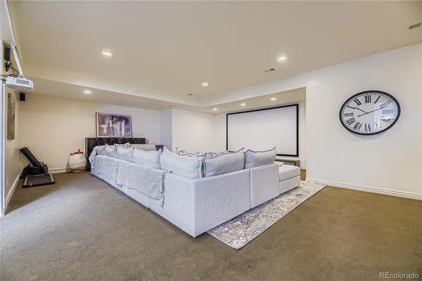 a living room with furniture and a clock