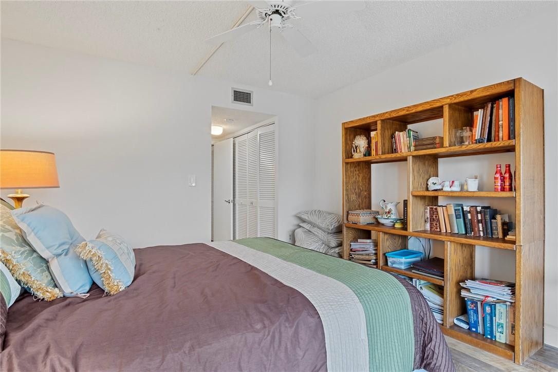 2810 North 46th Avenue, Unit 462 Hollywood, FL 33021 - Photo 11 of 31 a bedroom with a bed furniture and a book shelf