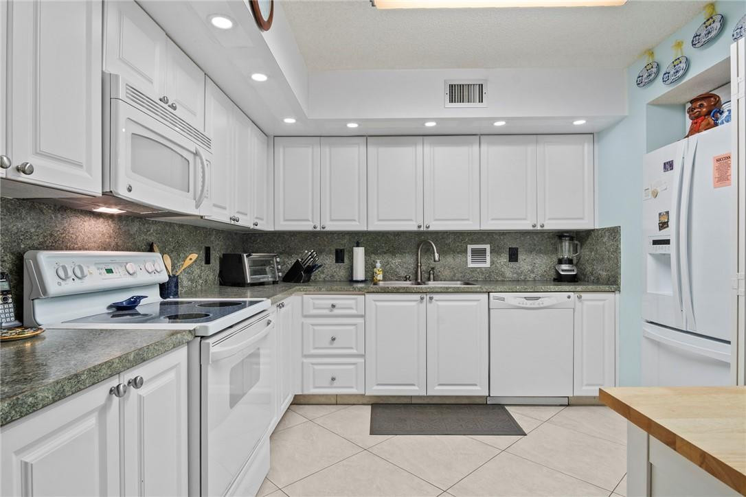 2810 North 46th Avenue, Unit 462 Hollywood, FL 33021 - Photo 2 of 31 a kitchen with stainless steel appliances granite countertop a sink and dishwasher