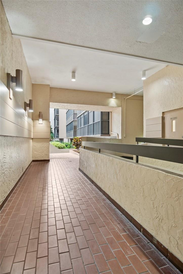 2810 North 46th Avenue, Unit 462 Hollywood, FL 33021 - Photo 24 of 31 a large white kitchen with a large window and stainless steel appliances