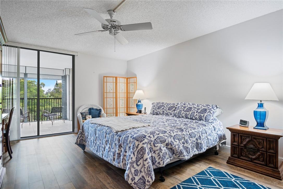 2810 North 46th Avenue, Unit 462 Hollywood, FL 33021 - Photo 3 of 31 a bedroom with a large bed and a chandelier fan