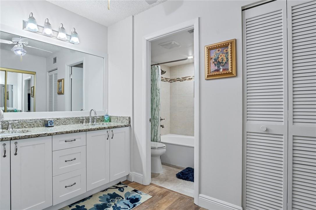 2810 North 46th Avenue, Unit 462 Hollywood, FL 33021 - Photo 4 of 31 a bathroom with a granite countertop sink and a mirror