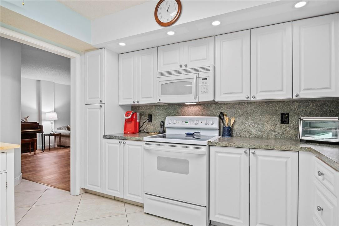 2810 North 46th Avenue, Unit 462 Hollywood, FL 33021 - Photo 5 of 31 a kitchen with stainless steel appliances granite countertop a sink and cabinets