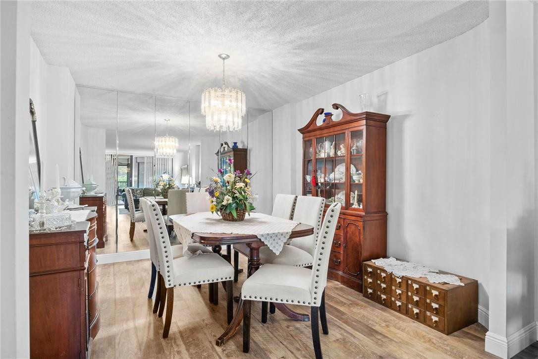 2810 North 46th Avenue, Unit 462 Hollywood, FL 33021 - Photo 6 of 31 a view of a dining room with furniture and chandelier