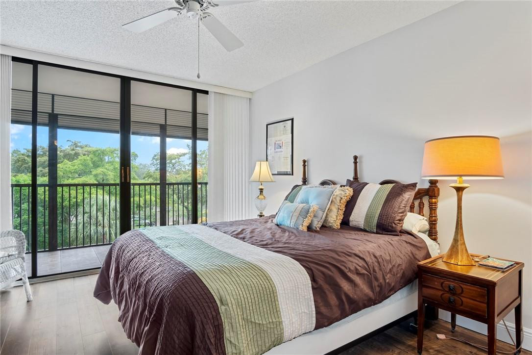 2810 North 46th Avenue, Unit 462 Hollywood, FL 33021 - Photo 10 of 31 a large bedroom with a bed and glass window