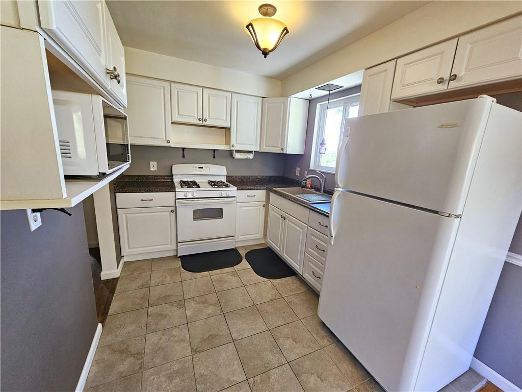 263 Lacock Street Washington, PA 15301 - Photo 6 of 33 a kitchen with a stove a refrigerator and a sink