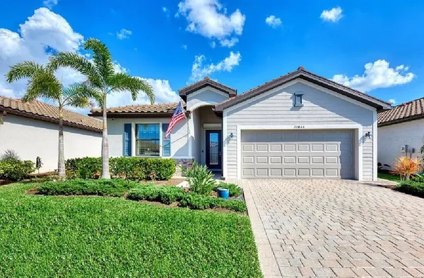 a front view of a house with a yard and garage