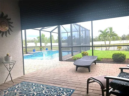 a living room with a floor to ceiling window and a table