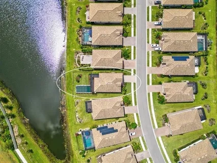 an aerial view of residential houses with outdoor space