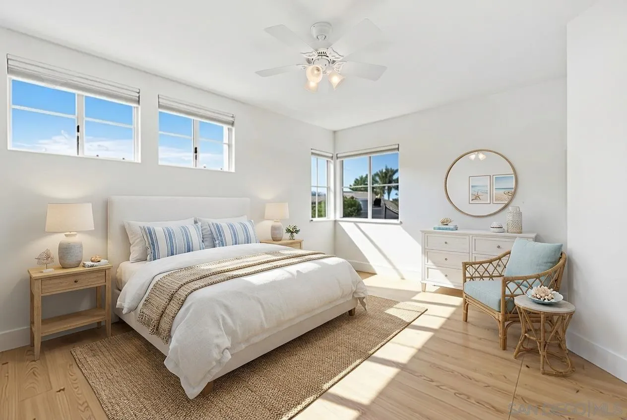 4802 Baroque Terrace Oceanside, CA 92057 - Photo 37 of 51 a bedroom with a bed a mirror and a lamp on dresser