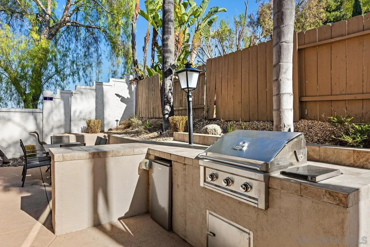 4802 Baroque Terrace Oceanside, CA 92057 - Photo 42 of 51 a view of a kitchen with a stove and a chair under an umbrella