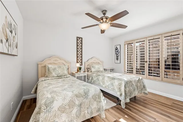 a bedroom with two large bed and a large window