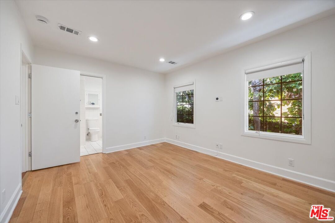 14041 Roblar Road Sherman Oaks, CA 91423 - Photo 22 of 47 a view of empty room with wooden floor and fan