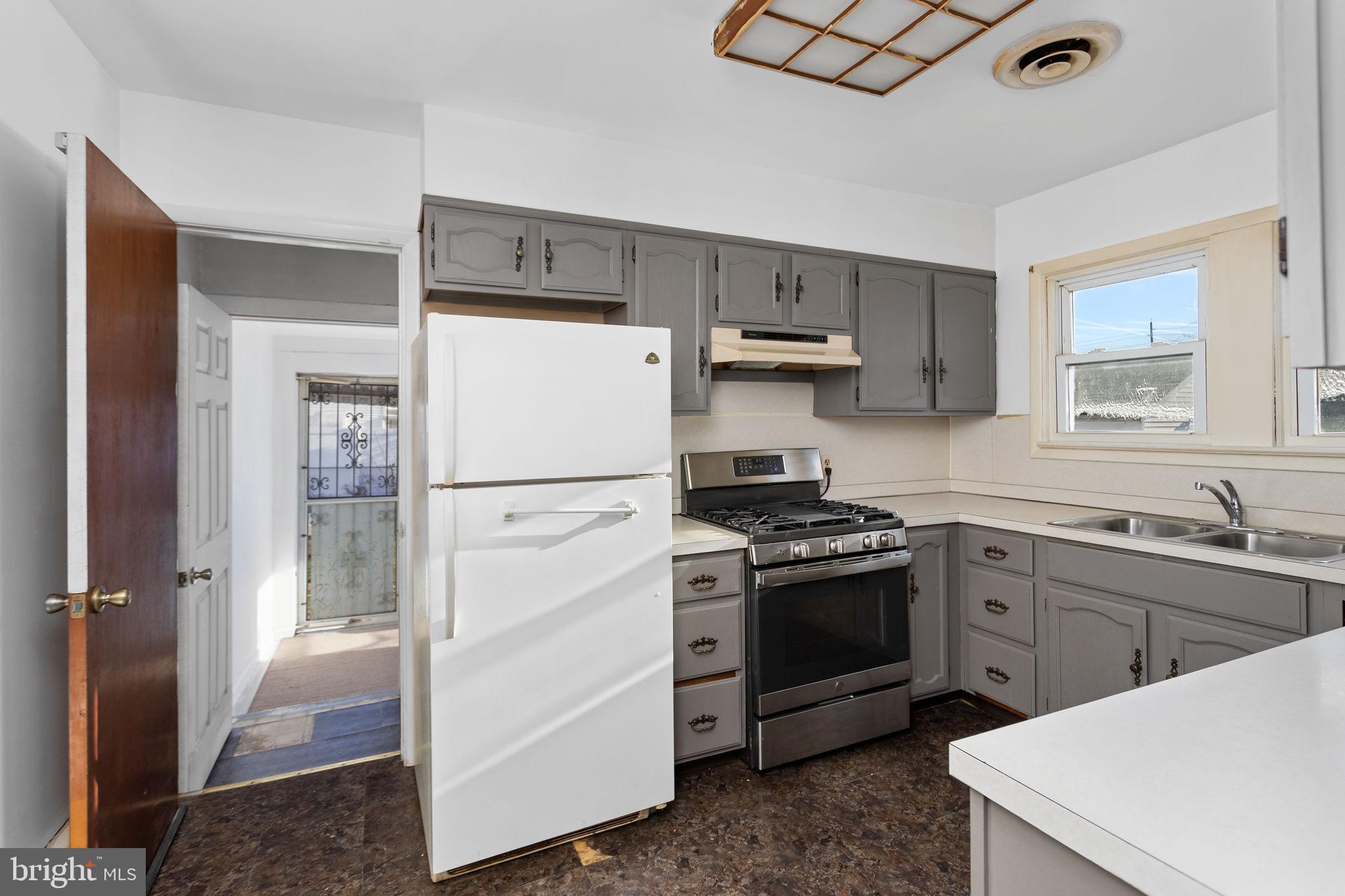 140 Maddock Avenue Hamilton, NJ 08610 - Photo 12 of 29 a kitchen with white cabinets and white appliances
